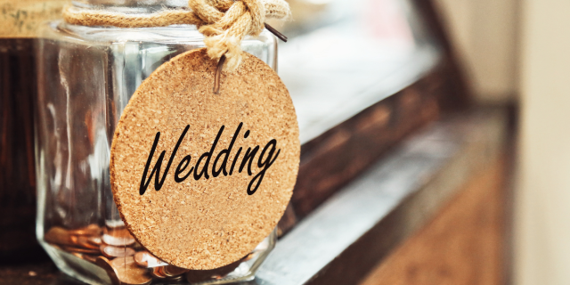 a coin jar labeled: WEDDING