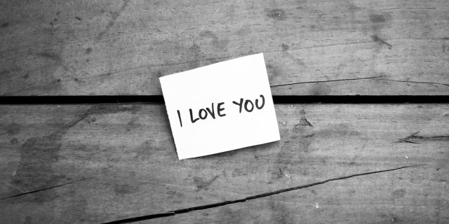 black and white image of a post it note that says "i love you"