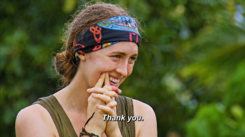 Frannie Marin, a contestant on Survivor season 44, smiles while looking off to the side, captioned "Thank you," as she just chose three other contestants to join her on the reward 