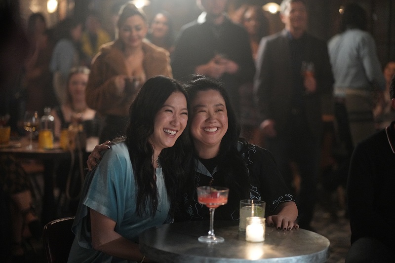 Alice and Sumi huddle together at the opening of Dennis' restaurant.