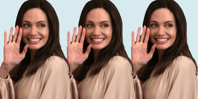 Angelina Jolie waving at a camera