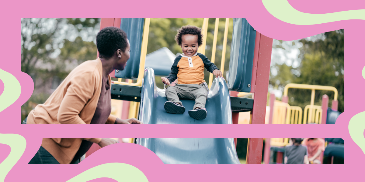 a Black mom with her toddler son sliding down a slide on a playground