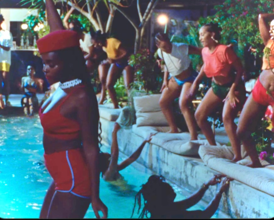 Janelle Monáe at a pool party in their music video.