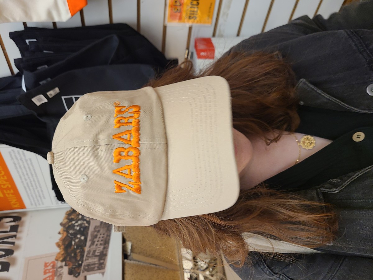 a tan hat with orange lettering that reads ZABAR'S