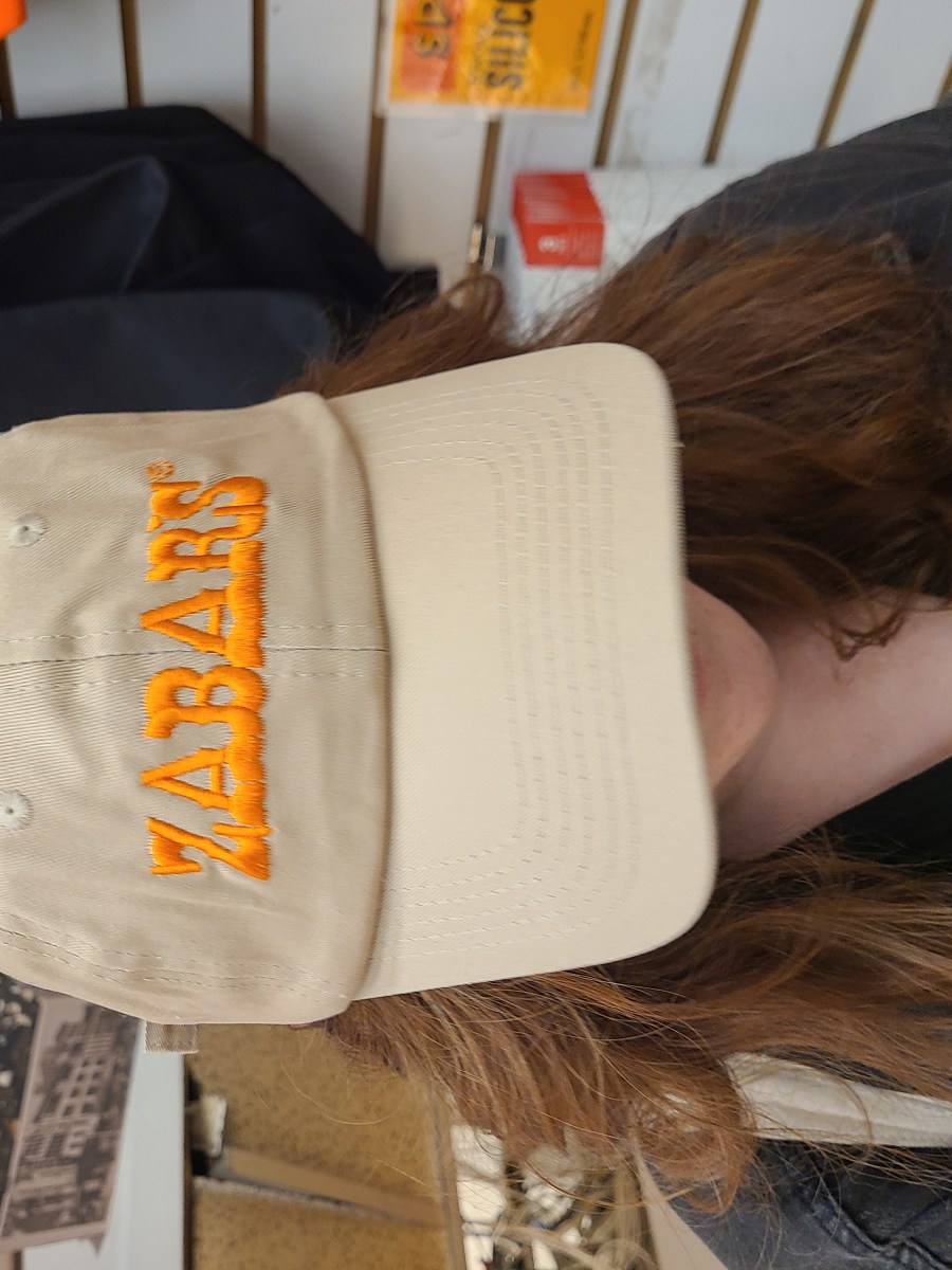 a tan hat with orange lettering that reads ZABAR'S