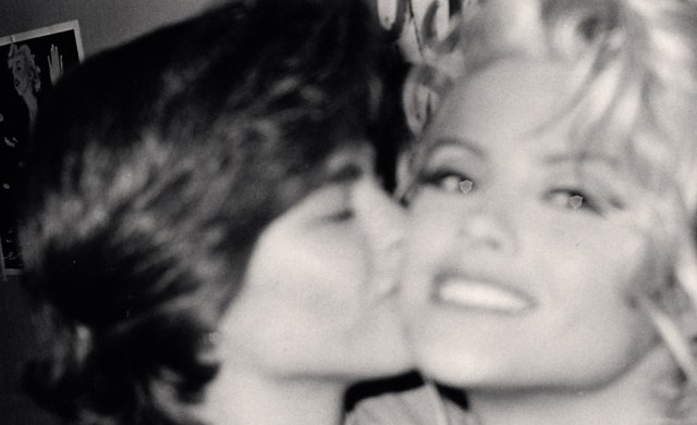A black and white photo of Missy Byrum and Anna Nicole Smith, with Missy kissing Anna's cheek