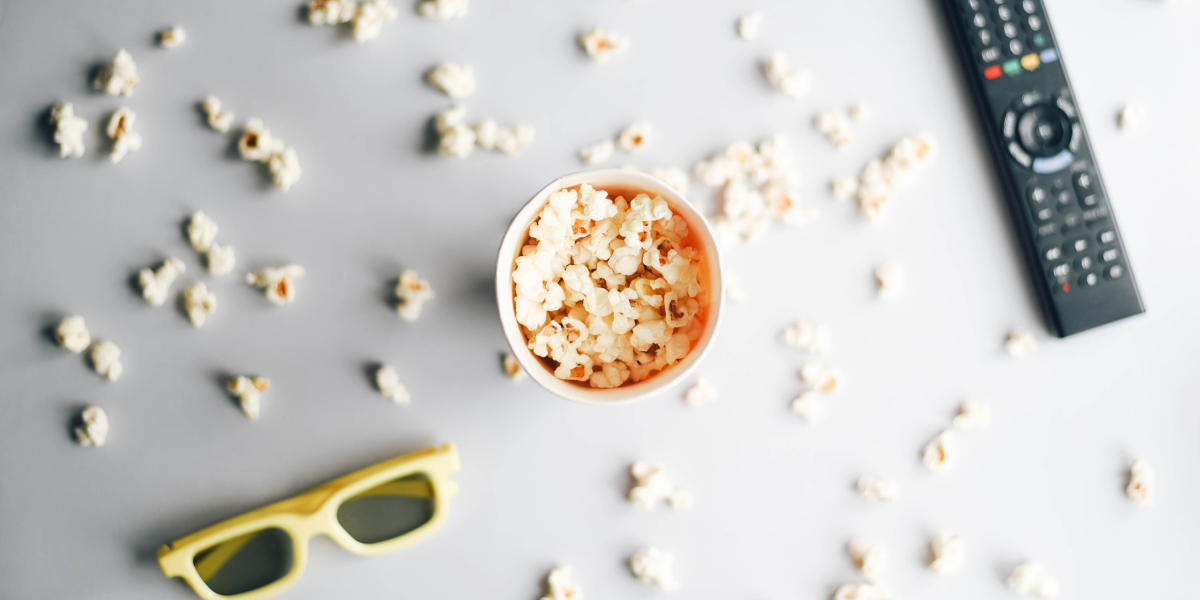 3d glasses, a bucket of popcorn, and a remote