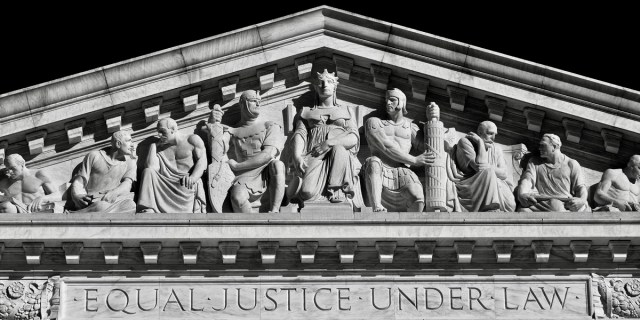 The inscription "Equal Justice Under Law" and accompanying sculpture by Robert Aitken representing "Liberty Enthroned Guarded by Order and Authority" above the main west entrance to the United States Supreme Court Building in Washington, D.C.