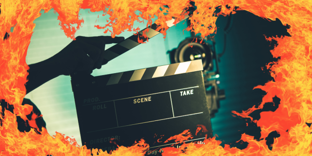 a film clapboard surrounded by flames