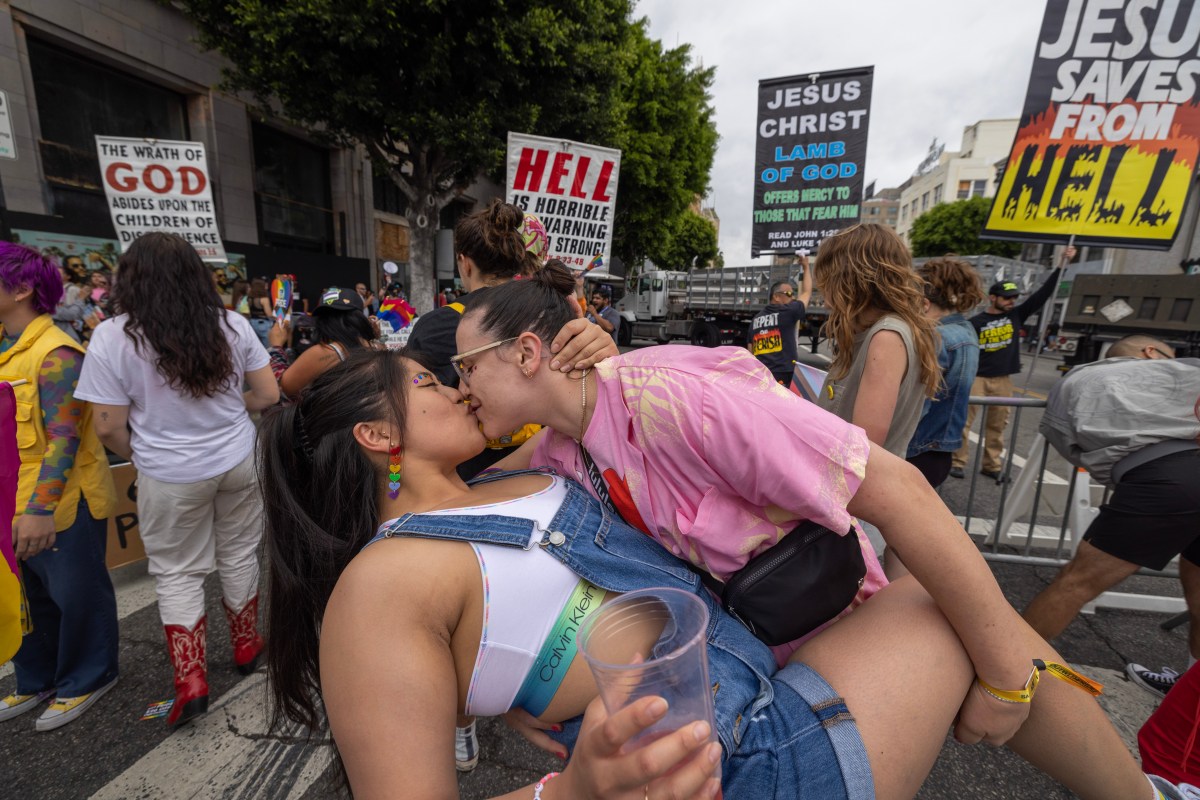 LOS ANGELES, CALIFORNIA - JUNE 11: People kiss in reaction to confrontational Evangelical Christians condemning the annual LA Pride Parade on June 11, 2023 in the Hollywood section of Los Angeles, California. The LA Pride Parade is one of the largest and oldest pride parades in the nation having begun one year after the 1969 'Stonewall Uprising' protest to a violent raid by police on gay patrons at the Stonewall Inn in New York City. The Gay Liberation Front responded by helping to organize gay parades in Los Angeles, San Francisco and New York City on that anniversary. Opposition to transexual rights and drag shows are currently major issues in Conservative politics. (Photo by David McNew/Getty Images)
