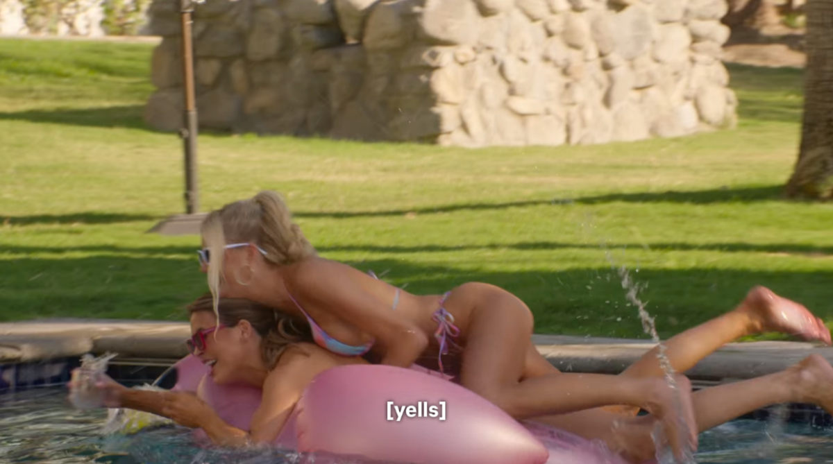 Emma jumps on Chrishell on a floatie in the pool