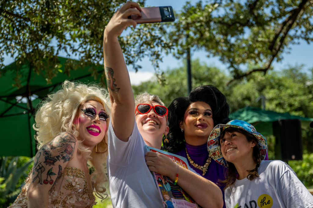 AUSTIN, TEXAS - JUNE 10: Austin, Tx drag queen Brigitte Bandit takes pictures with guests at the conclusion of a drag time story hour at the Waterloo Greenway park on June 10, 2023 in Austin, Texas. The Texas Senate has passed a pair of bills that defund public libraries that host Drag Queen Story Hour. The bills seek to prevent children's exposure to sexualized performances by criminalizing events where people perform under the guise of the opposite gender. (Photo by Brandon Bell/Getty Images)