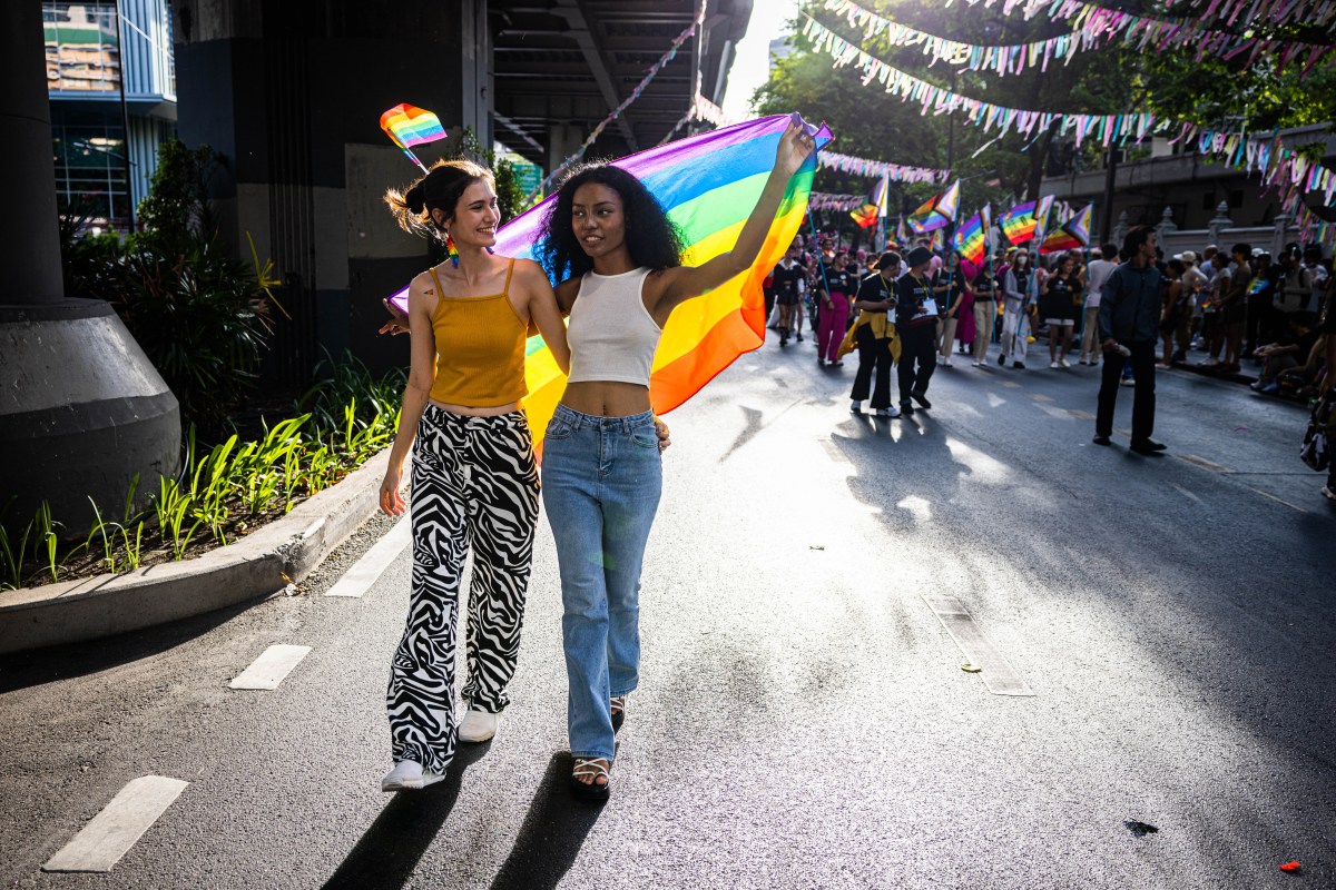 BANGKOK, THAILAND - JUNE 04: Attendees wave a rainbow flag during a Pride parade on June 04, 2023 in Bangkok, Thailand. Members of the LGBTQ community and allies take part in a Pride month march through central Bangkok. (Photo by Lauren DeCicca/Getty Images)