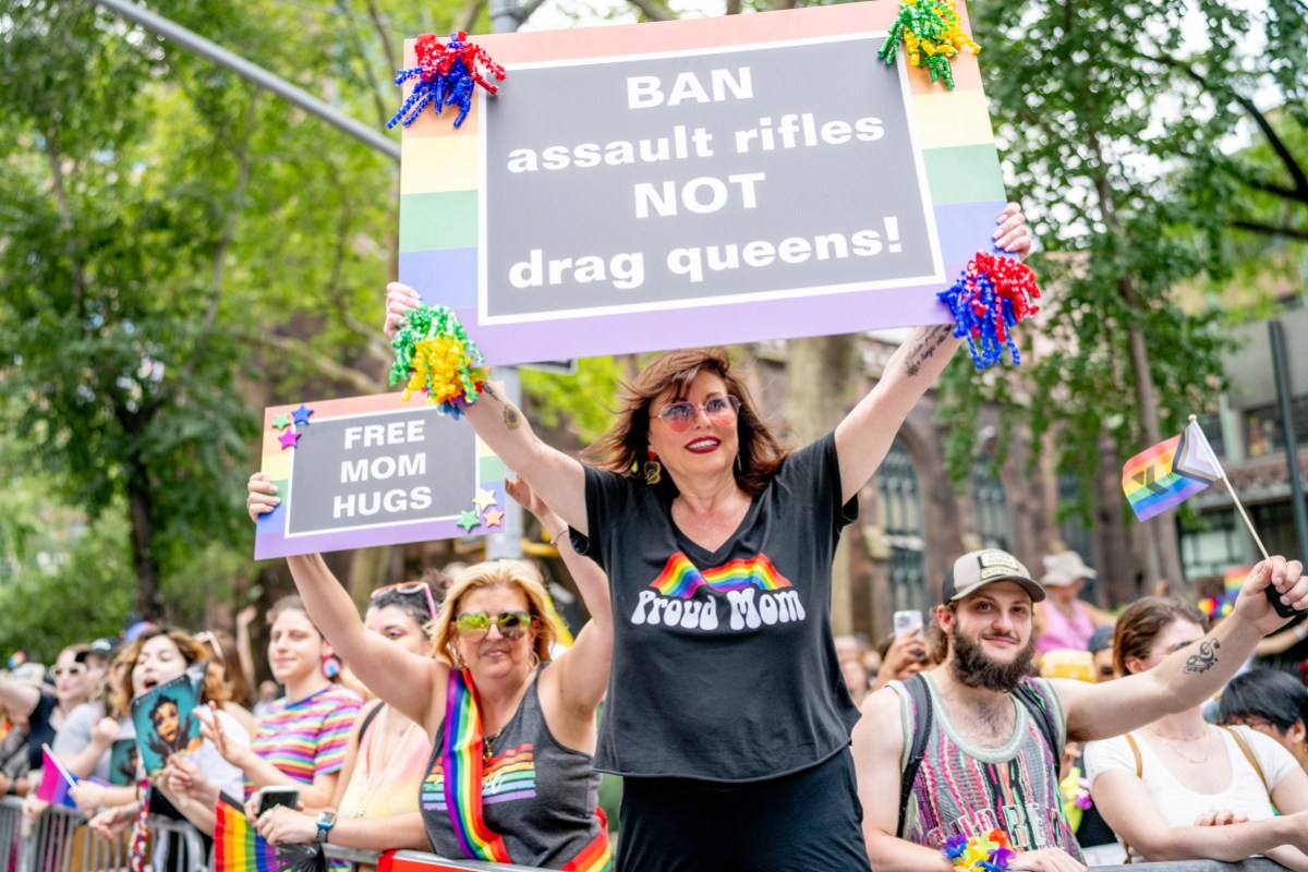 NEW YORK, NEW YORK - JUNE 25: A spectator in holds a sign reeding "BAN assault rifles NOT drag queens" during the 2023 New York City Pride March on June 25, 2023 in New York City. 