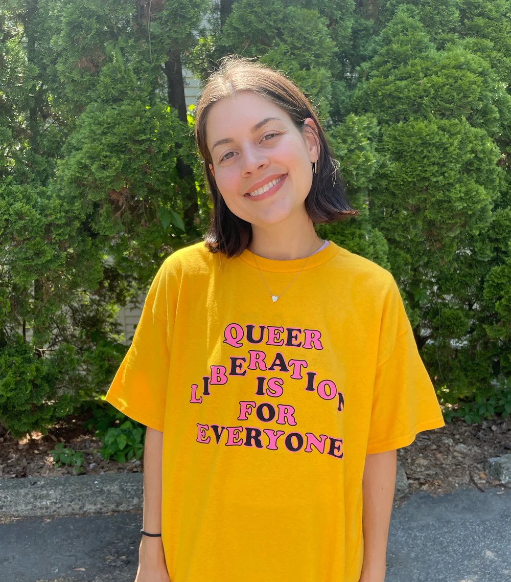 yellow t-shirt that says QUEER LIBERATION IS FOR EVERYONE