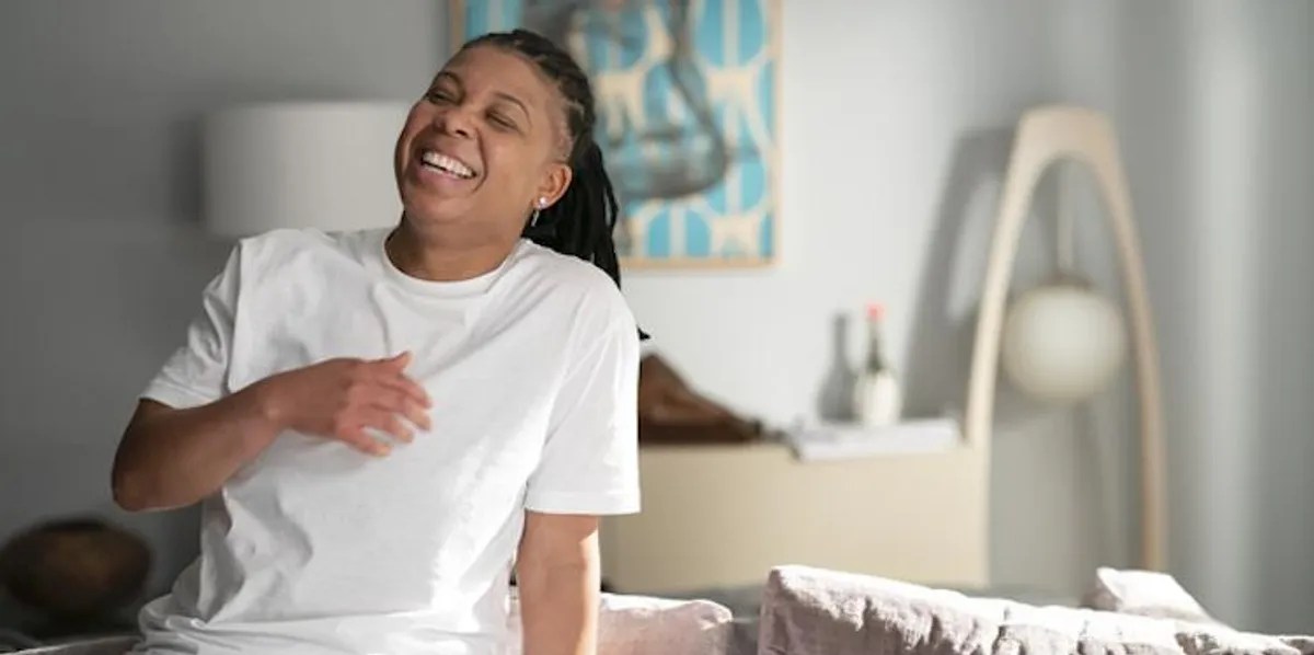 Punkie Johnson laughing in a white t-shirt