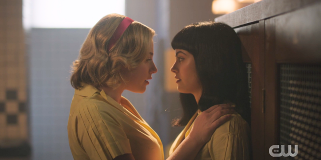 Betty and Veronica pressed close together against the lockers in Riverdale season 7