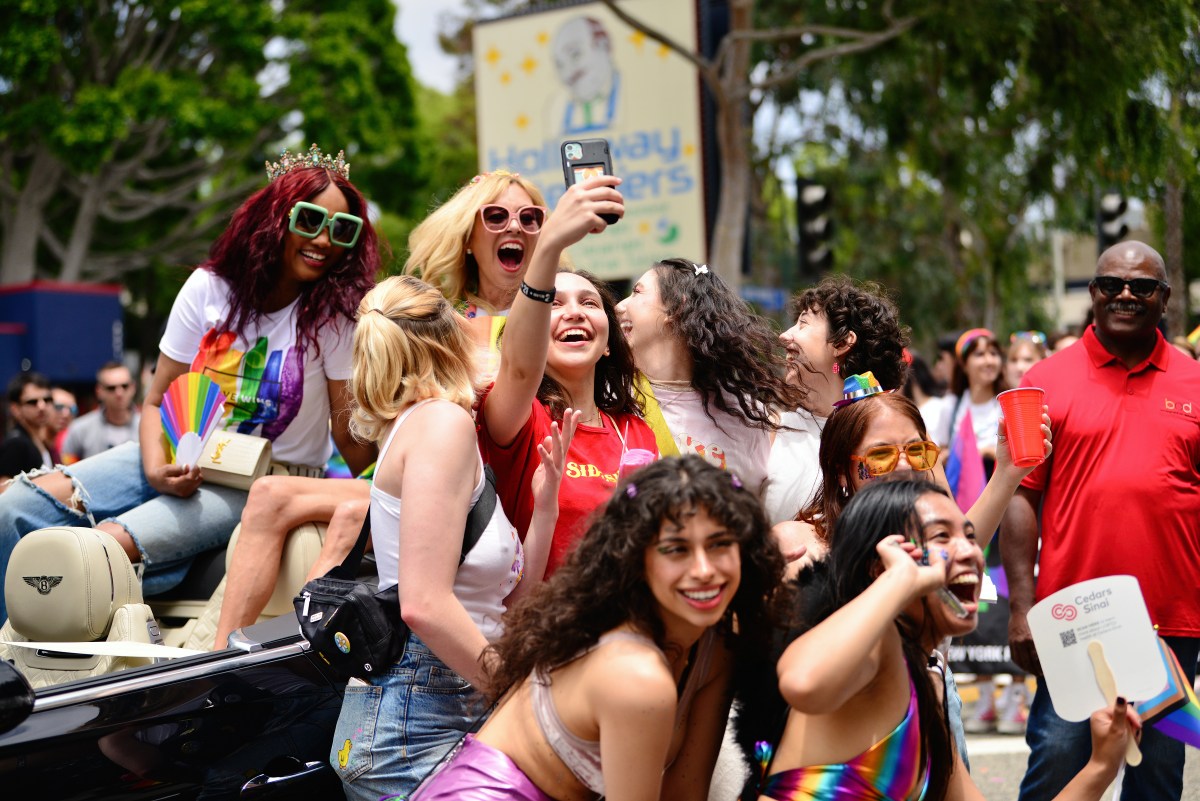 WEST HOLLYWOOD, CALIFORNIA - JUNE 04: TV personalities Garcelle Beauvais and Sutton Stracke pose for a selfie with fans at the 2023 WeHo Pride Parade on June 04, 2023 in West Hollywood, California. (Photo by Chelsea Guglielmino/Getty Images)