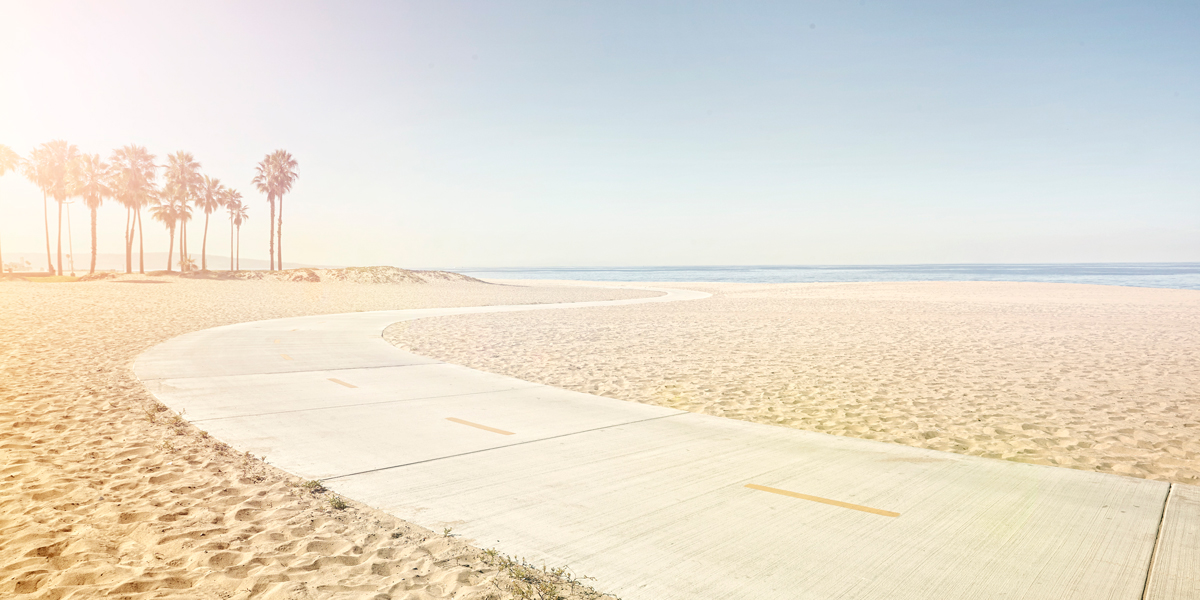 A beach at sunset with an instagram filter over it to look like a vintage postcard.