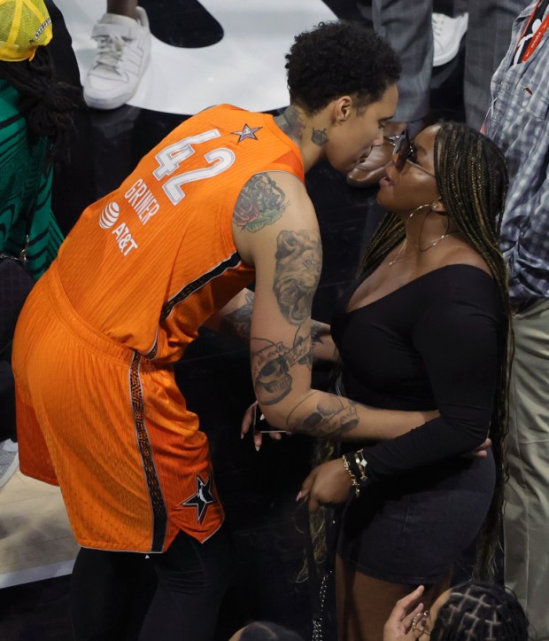 Brittney Griner bends down to kiss her wife Cherelle Griner at the 2023 WNBA All Star game.