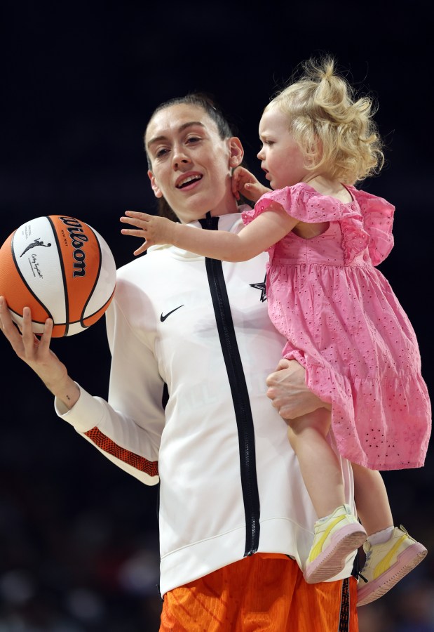 Breanna Stewart holding her daughter Ruby during the 2023 WNBA All Star Game warm ups.