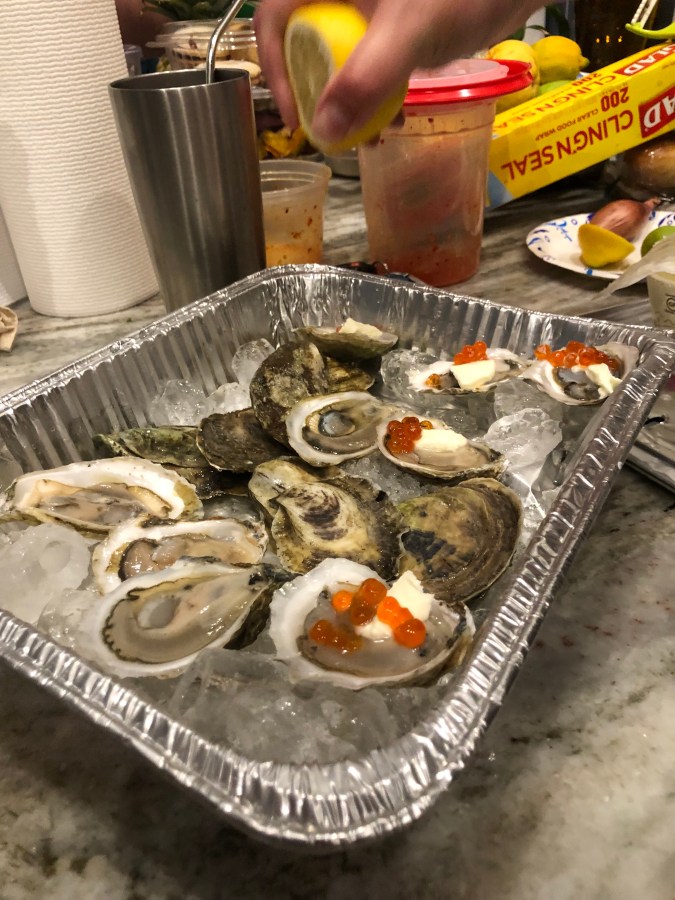 oysters topped with salmon roe and creme fraiche
