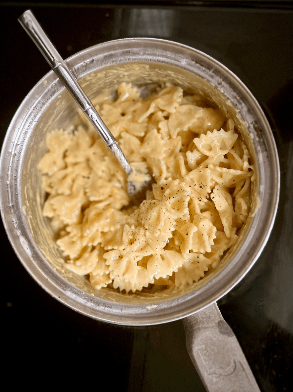 A close up of a photo of easy stovetop macaroni and cheese, made in 20 minutes, with bowtie pasta