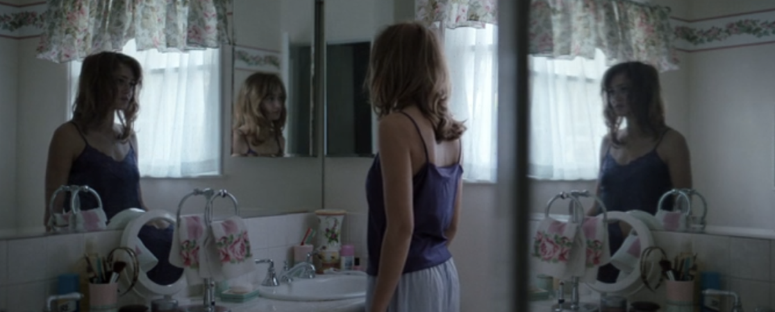 Jackie looking at herself in the mirror in the Yellowjackets pilot