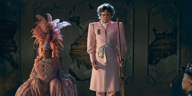 A still from Playland features two actors in pink suits on stage