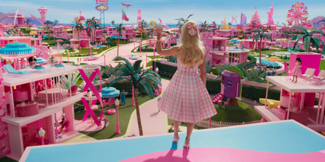Barbie waving to Barbieland, a pink and pastel wonderland, in the movie Barbie