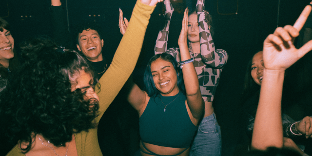 a group of friends dancing at a club