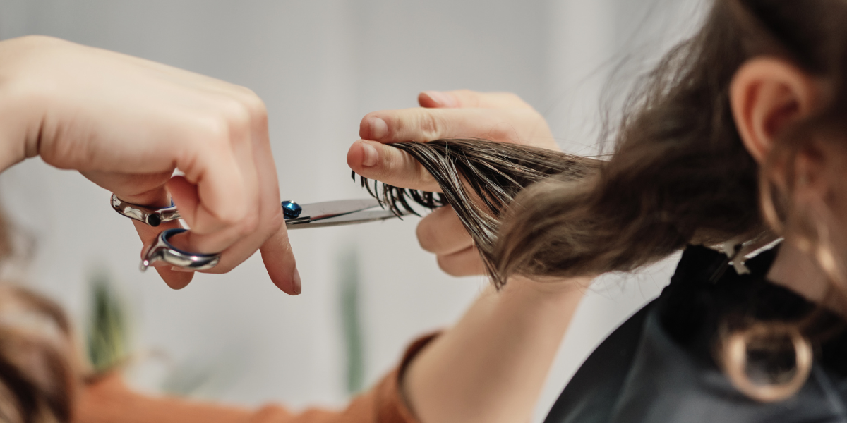 hands cutting hair in a salon