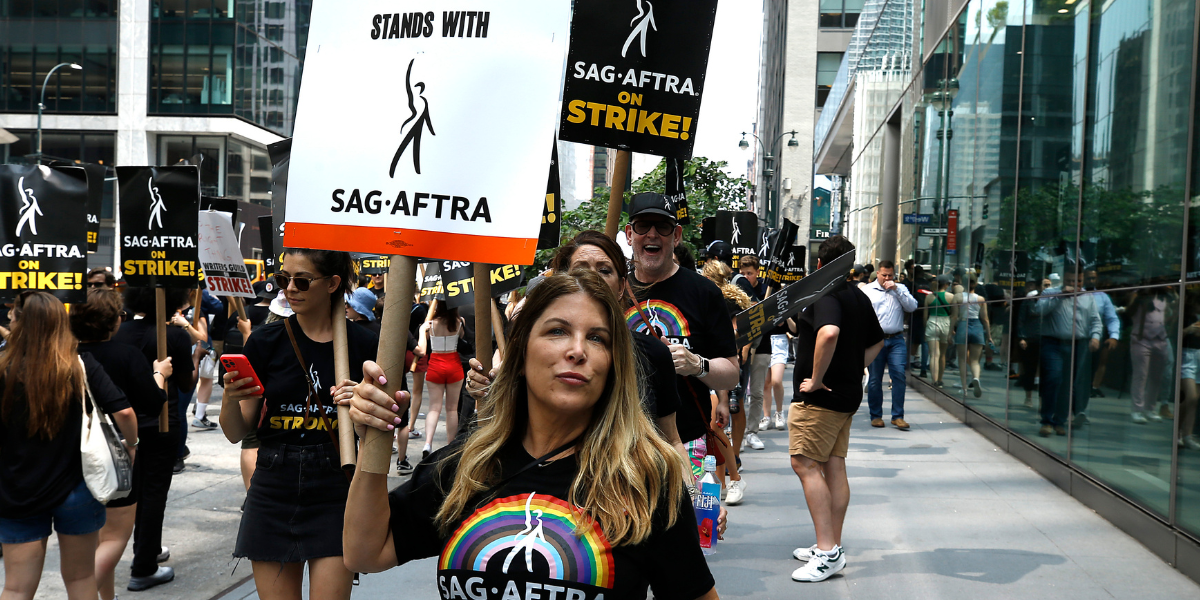 the SAG-AFTRA strike including a person wearing a shirt with a rainbow on it