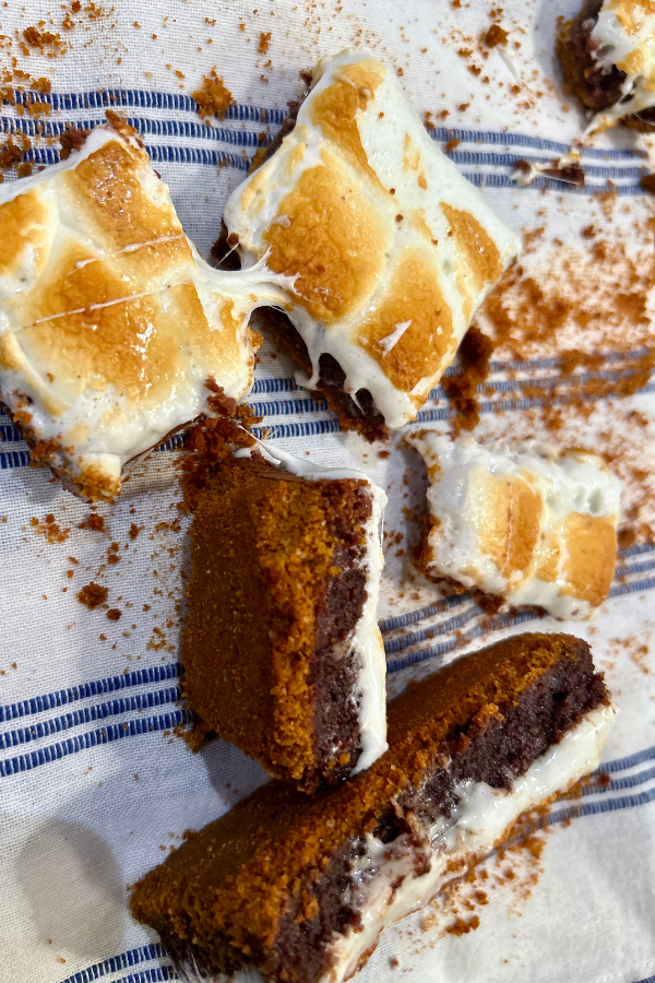 S'mores Brownies, strewn about messily over a blue and white table cloth