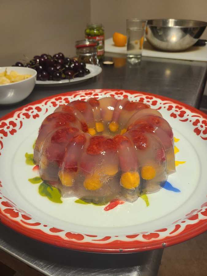 a sweet aspic on a plate with red trim