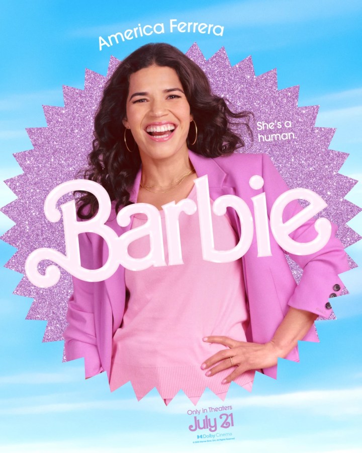 America Ferrera as Gloria (she's in a pink shirt and lavender blazer)