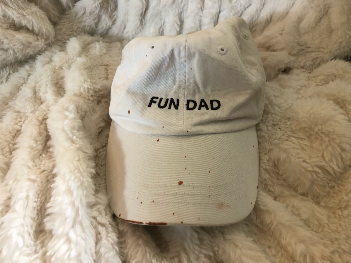 a white hat that says FUN DAD and is splattered with what looks like blood but it isn't!