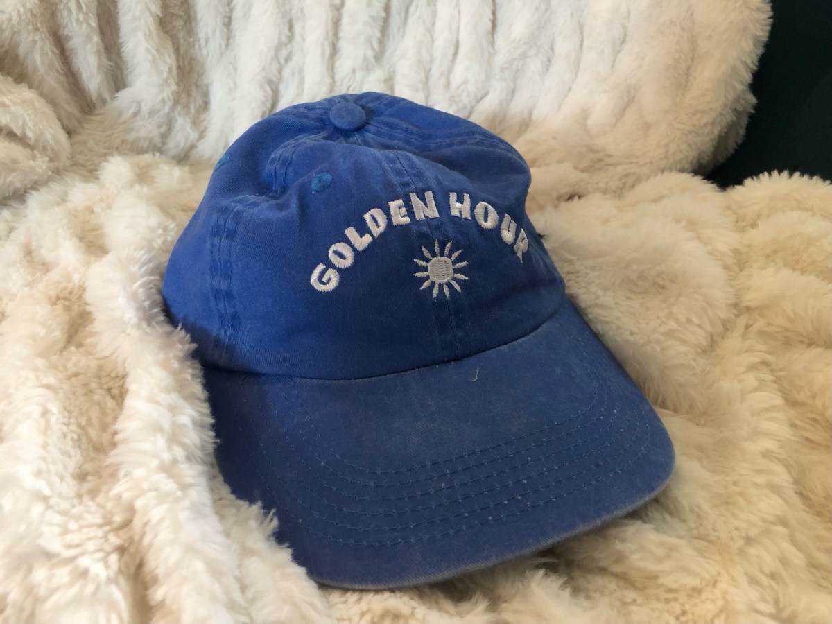 a blue hat that says GOLDEN HOUR with a sun on it