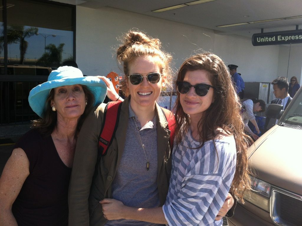 the author in aviators and a green jacket with the author's mother and sister