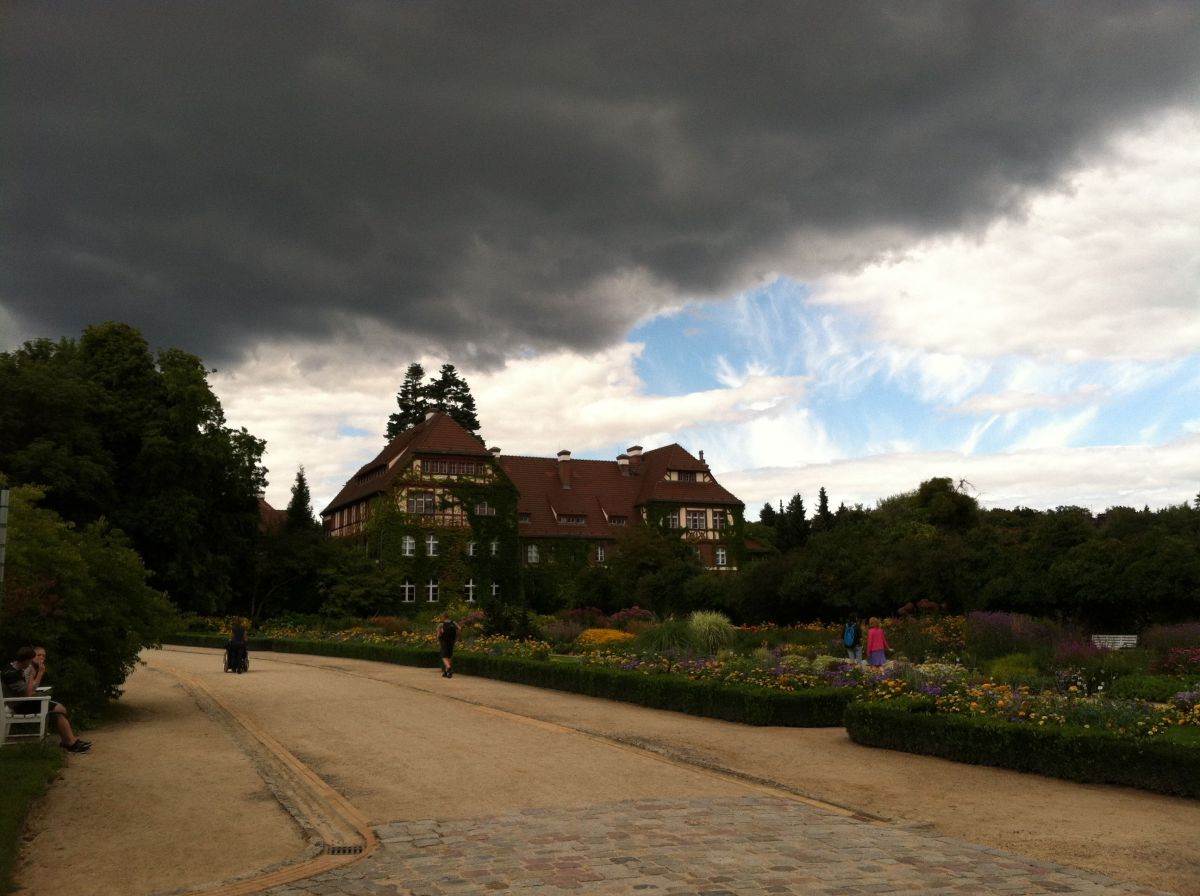 a cloudy day in Berlin with a large house looming in the background