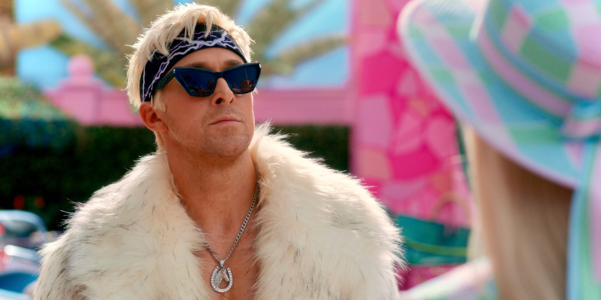 Ken (Ryan Gosling, in the Barbie movie) wears dark sunglasses and a white fur coat, open with his chest exposed and a silver chain. He looks smugly at Barbie.