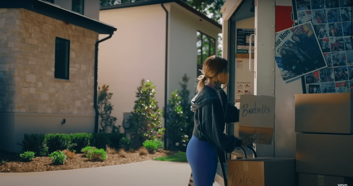 Morgan unloading Barbells from a UHaul in the Fall in Love With Me music video