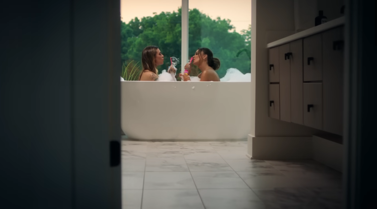 Morgan and Kyle in a tub blowing bubbles together in the Fall in Love With Me music video