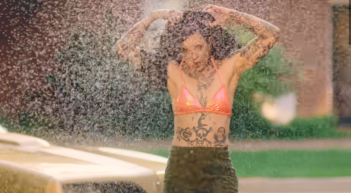 Morgan Wade taking off her shirt while surrounded by water in the Fall in Love With Me music video