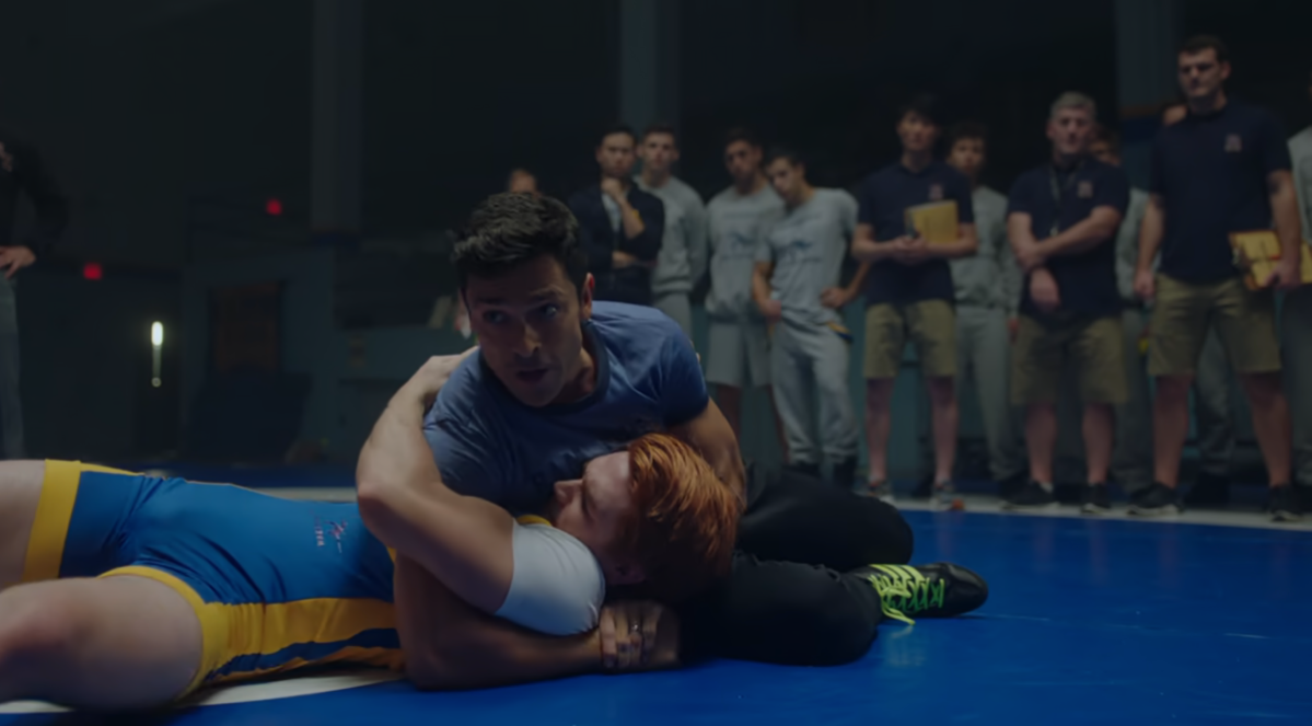 Hiram pinning Archie on a wrestling mat in Riverdale