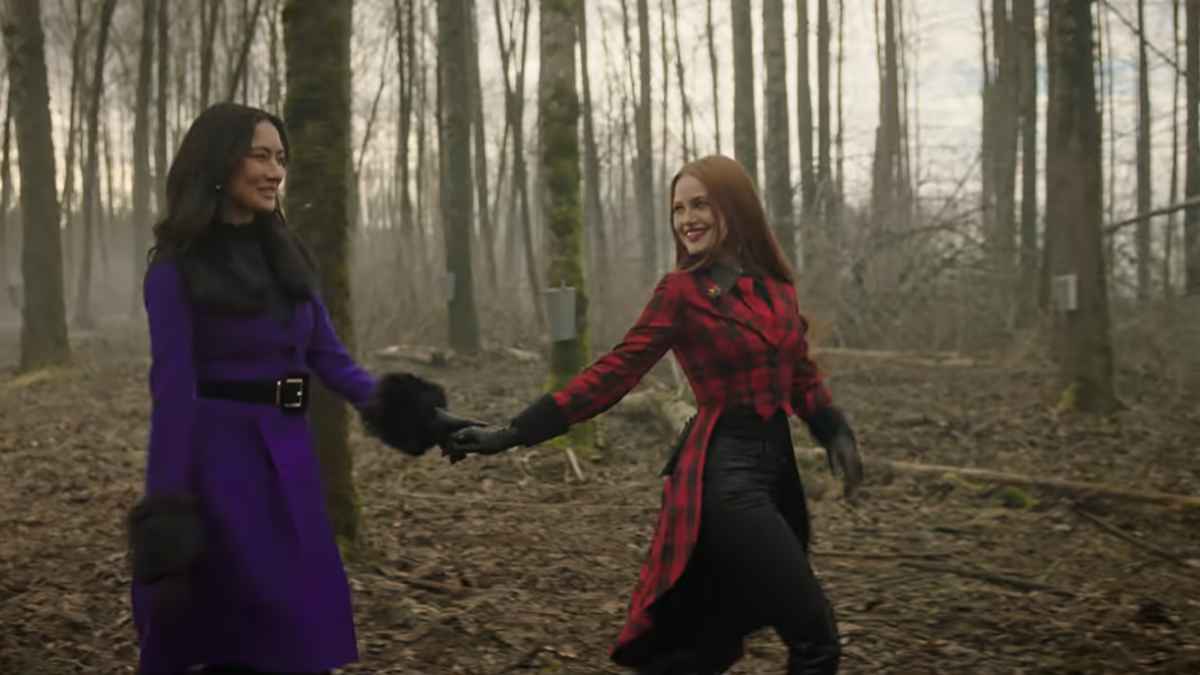 Minerva holding Cheryl's hand in the woods in Riverdale