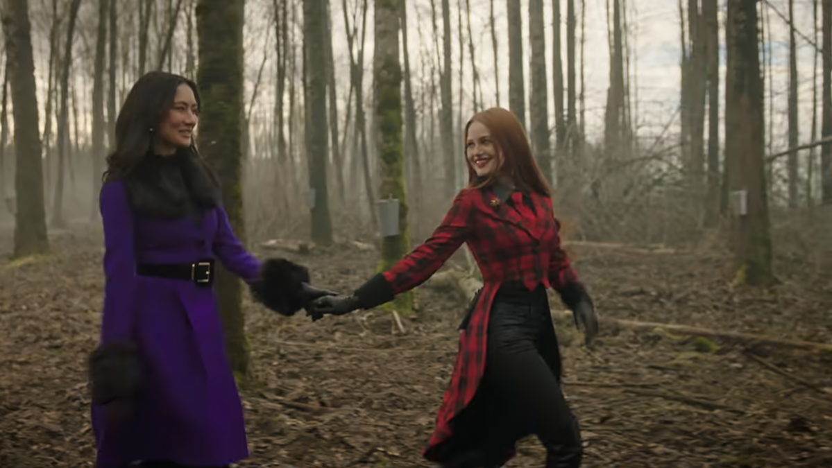 Minerva holding Cheryl's hand in the woods in Riverdale