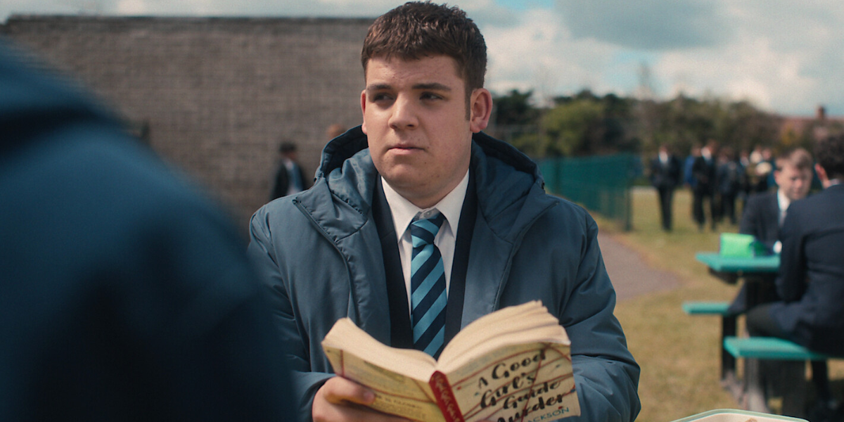 Isaac in Heartstopper season 2 holds a book