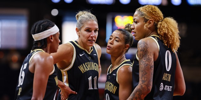 Elena Delle Donne #11 of the Washington Mystics huddles with Brittney Sykes #15, Natasha Cloud #9, and Shakira Austin #0 during the first half of the game against the Dallas Wings