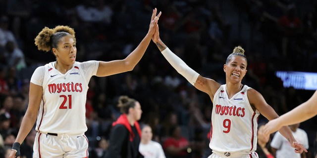 LAS VEGAS, NEVADA - AUGUST 11: Tianna Hawkins #21 and Natasha Cloud #9 of the Washington Mystics high-five after Hawkins hit a 3-pointer against the Las Vegas Aces in the third quarter of their game at Michelob ULTRA Arena on August 11, 2023